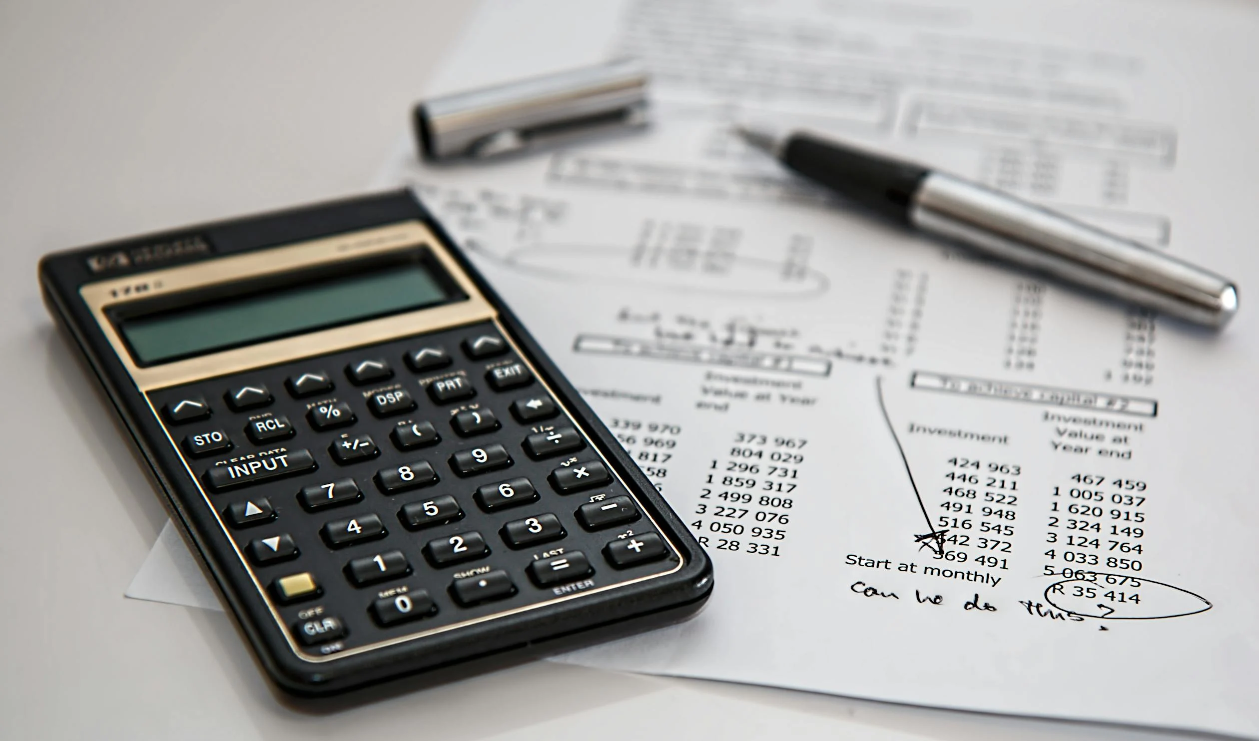 Image showing someone calculating short term rental management fees in Dubai