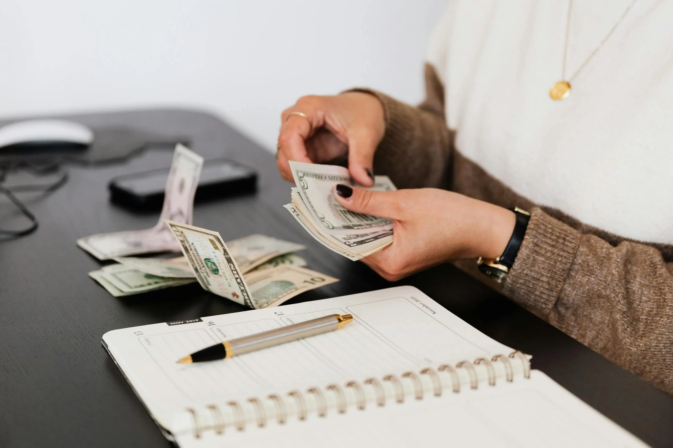 Photo showing a woman counting money made from vacation rentals