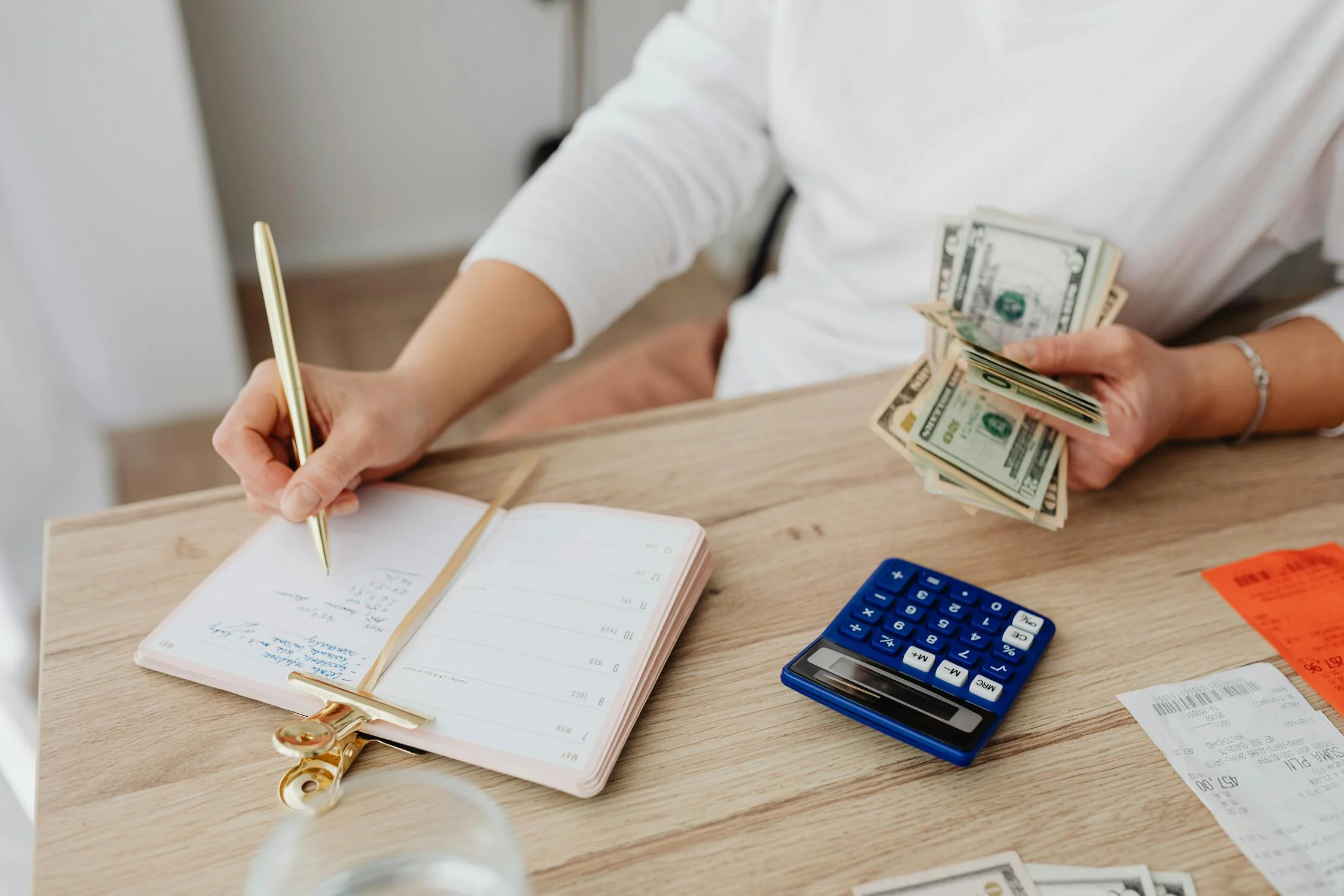 Image showing a woman calculating the ROI of 2 bedroom Airbnb apartments in Dubai