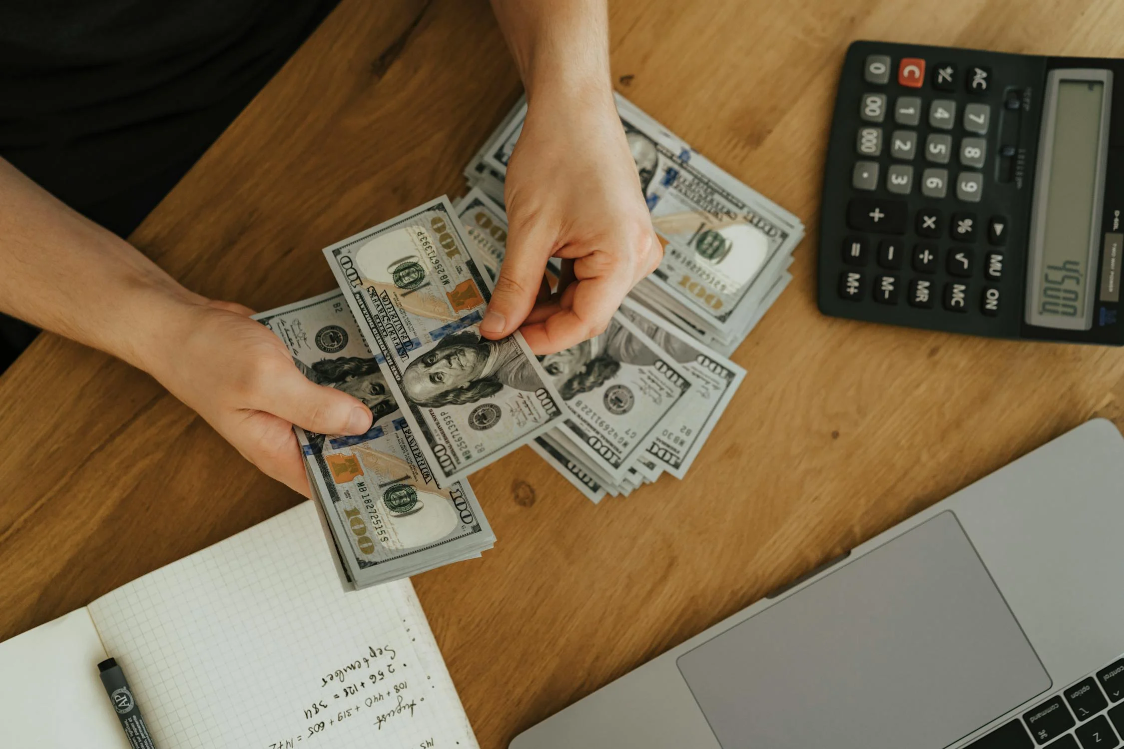 Image showing a woman calculating the cost of vacation rental management