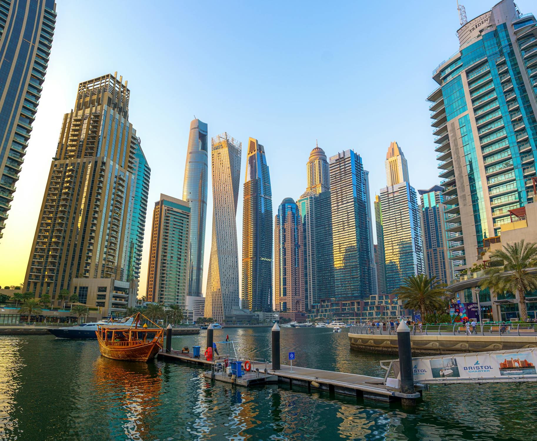 Photo showing a boat and high-rise buildings during sunset