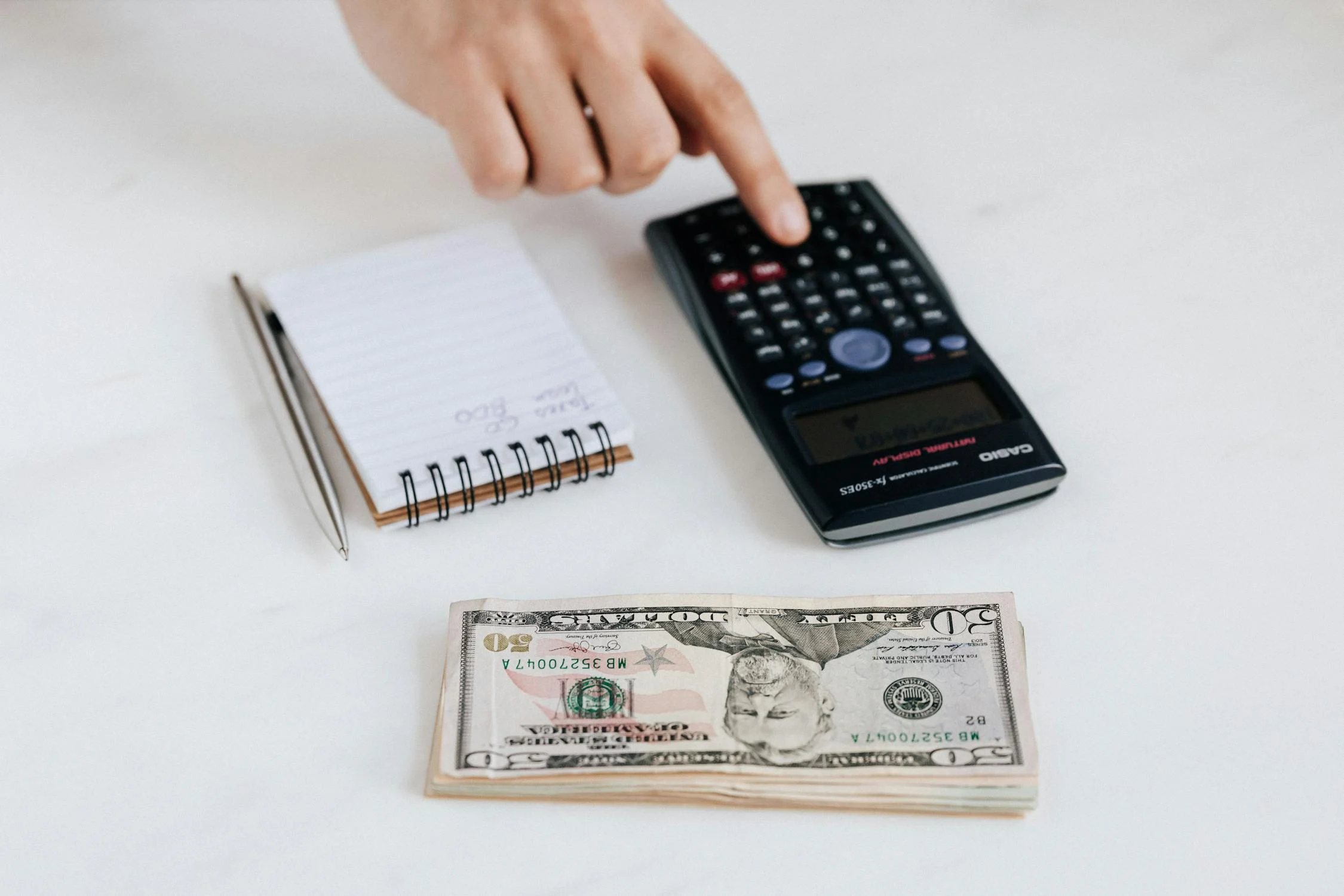 A person analyzing costs to determine if investing in a gadget setup for your short-term rental is a smart financial decision.