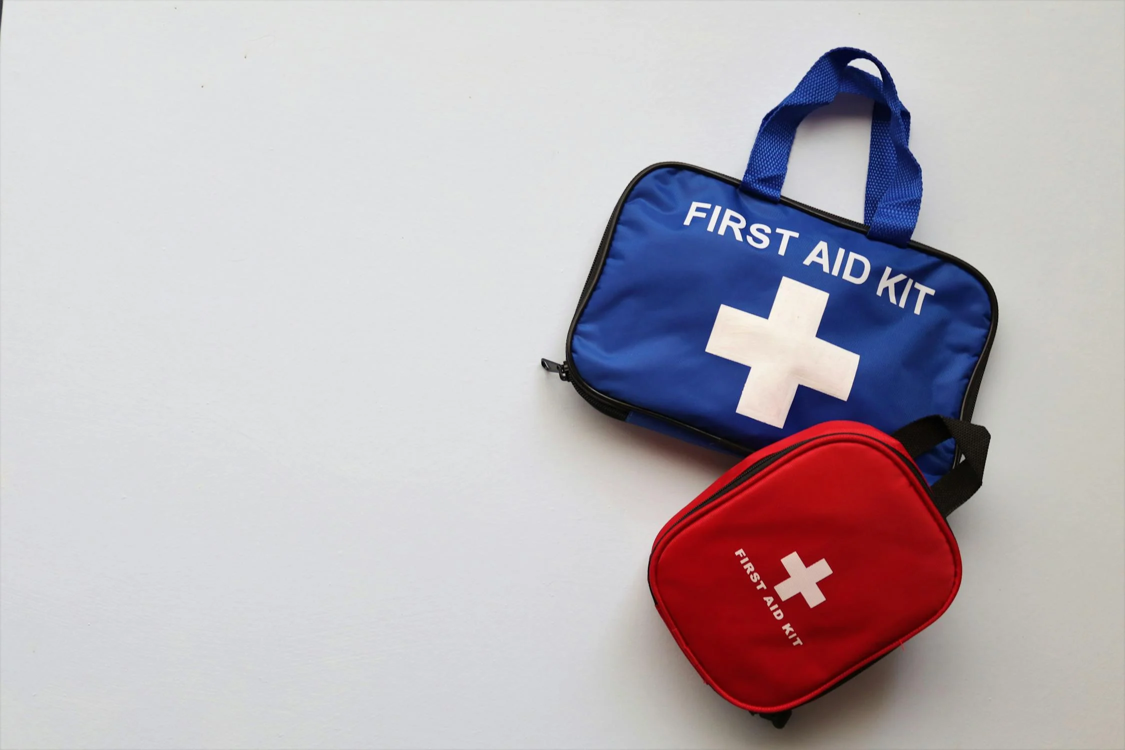A blue and a red first aid kit 