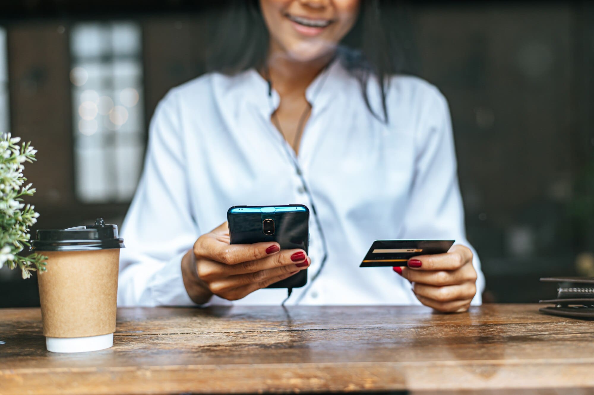 A lady paying for holiday home onboarding fees through her smartphone 