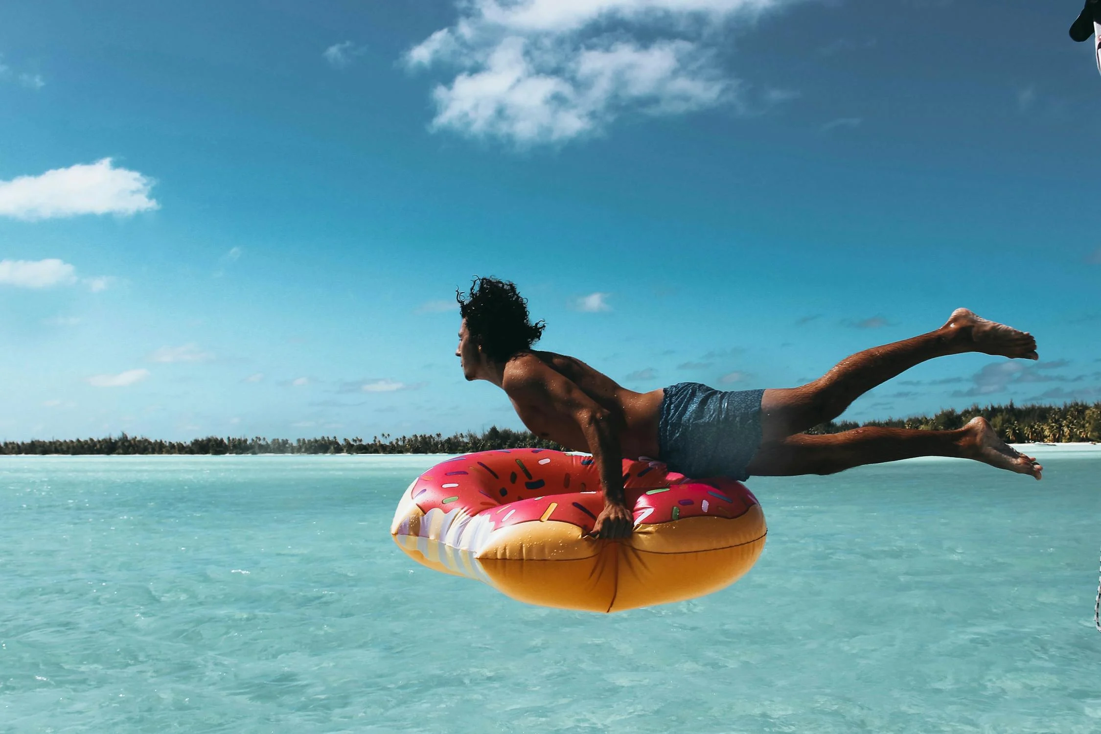 Man on a floater on the beach