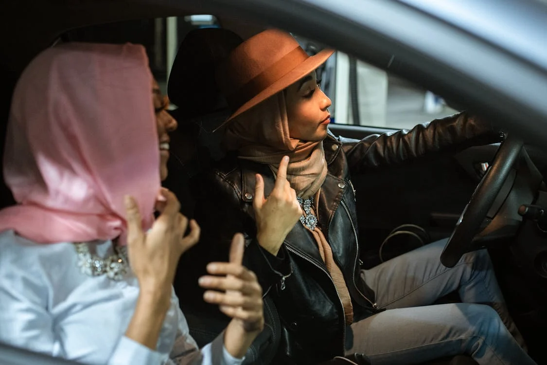 A photo of two tourists getting around with a car
