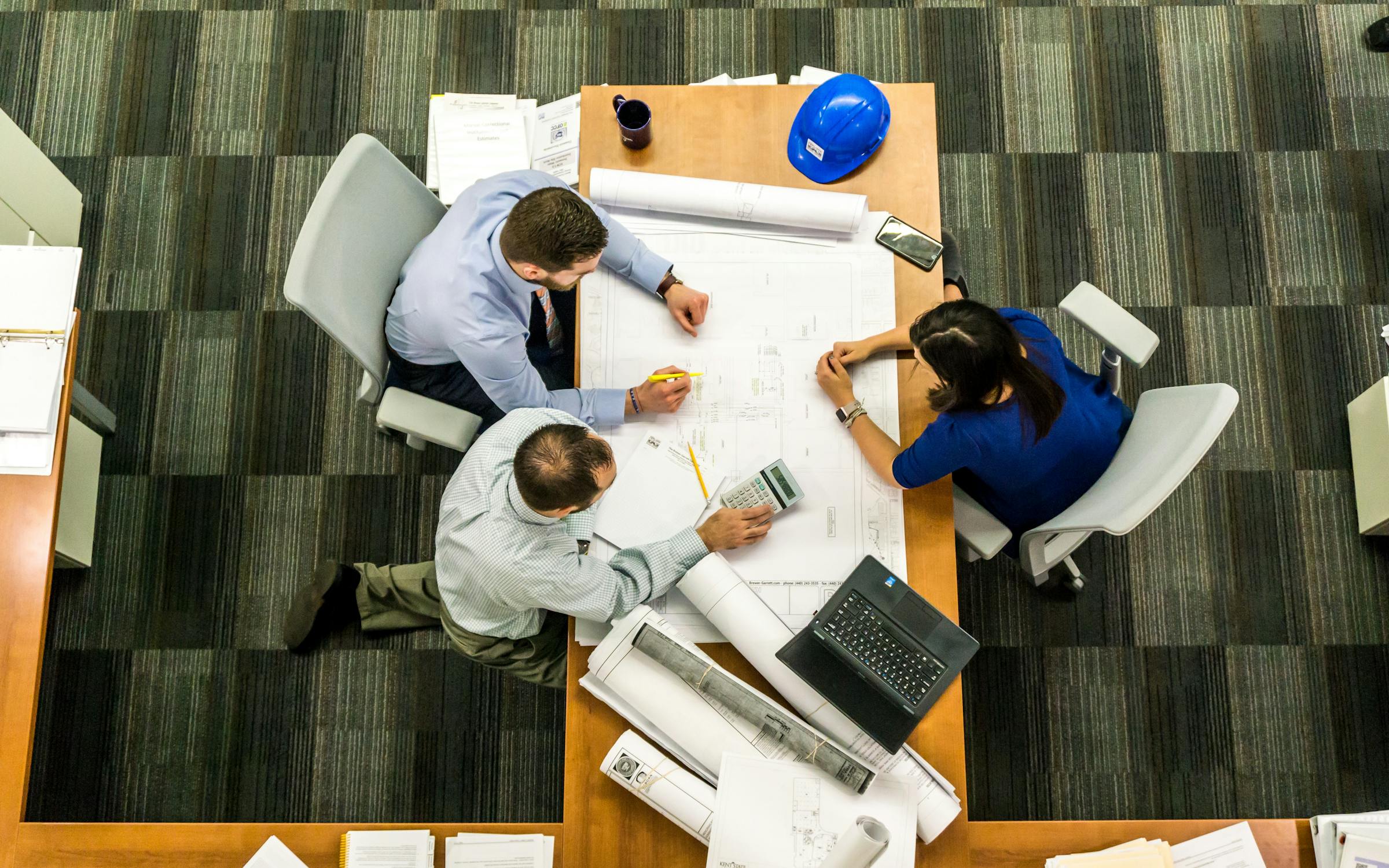 A property management team engaged in a discussion around a conference table.