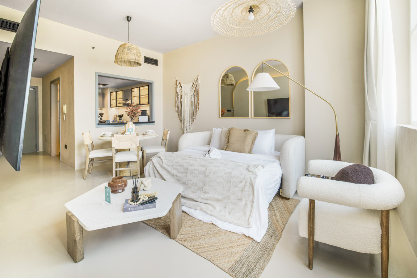 Soft neutral living room with arched mirrors in a one-bedroom Dubai Marina apartment.