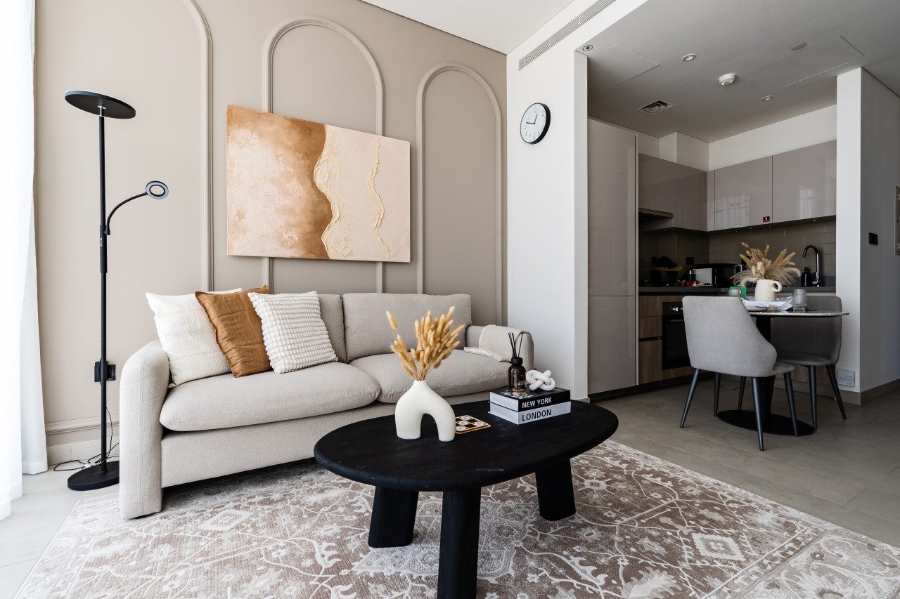 Area rug separates the living room from the dining area in an open-plan space. 