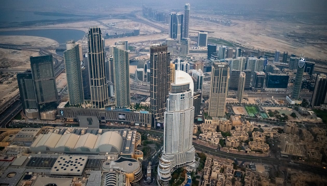 Aerial view of Dubai towers and new developments stretching into the desert, showing how much supply surrounds each building.