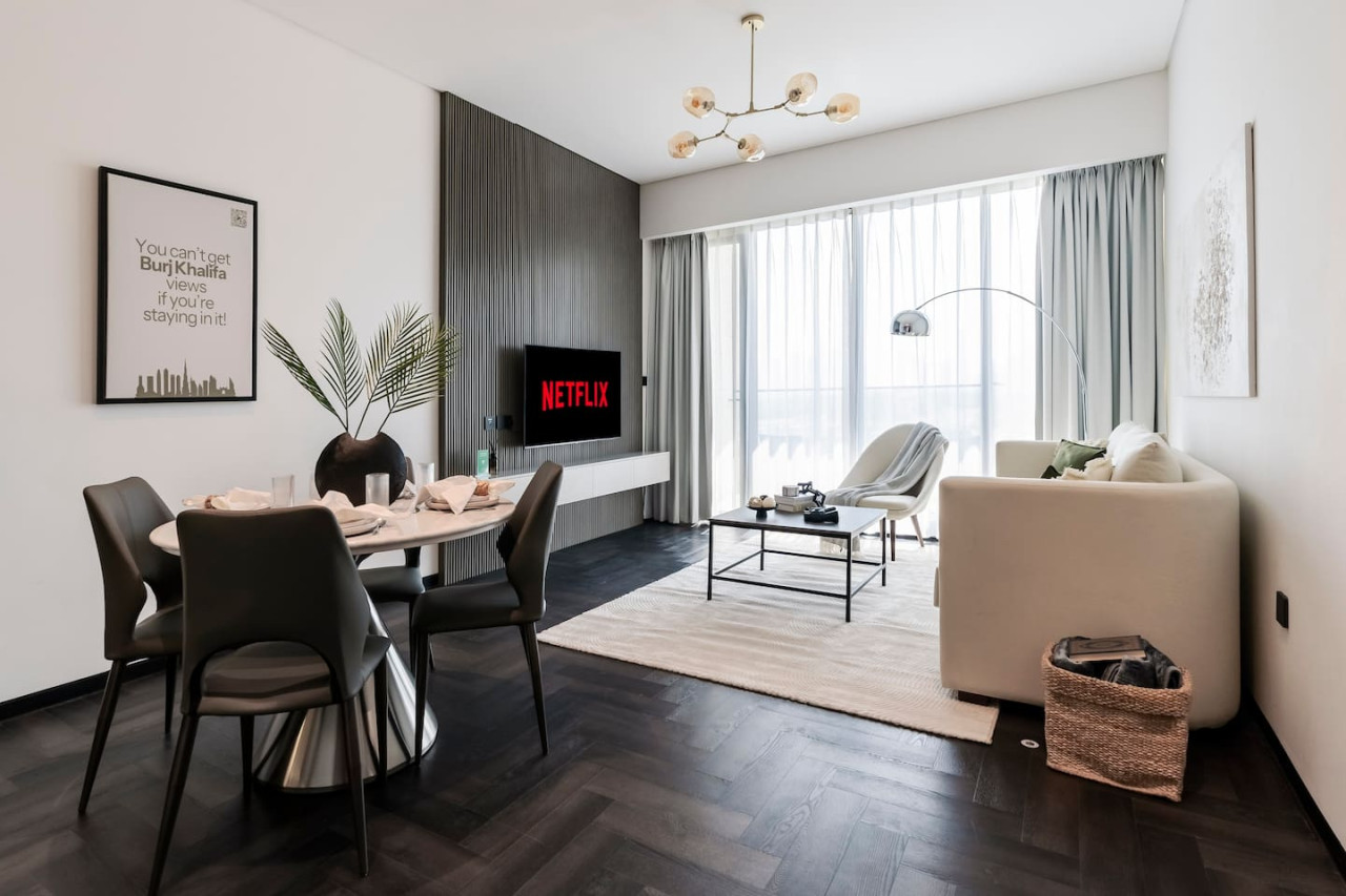 Dining area and living room separated by soft furnishing