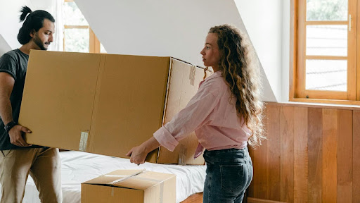 Airbnb hosts preparing a new rental by furnishing the space