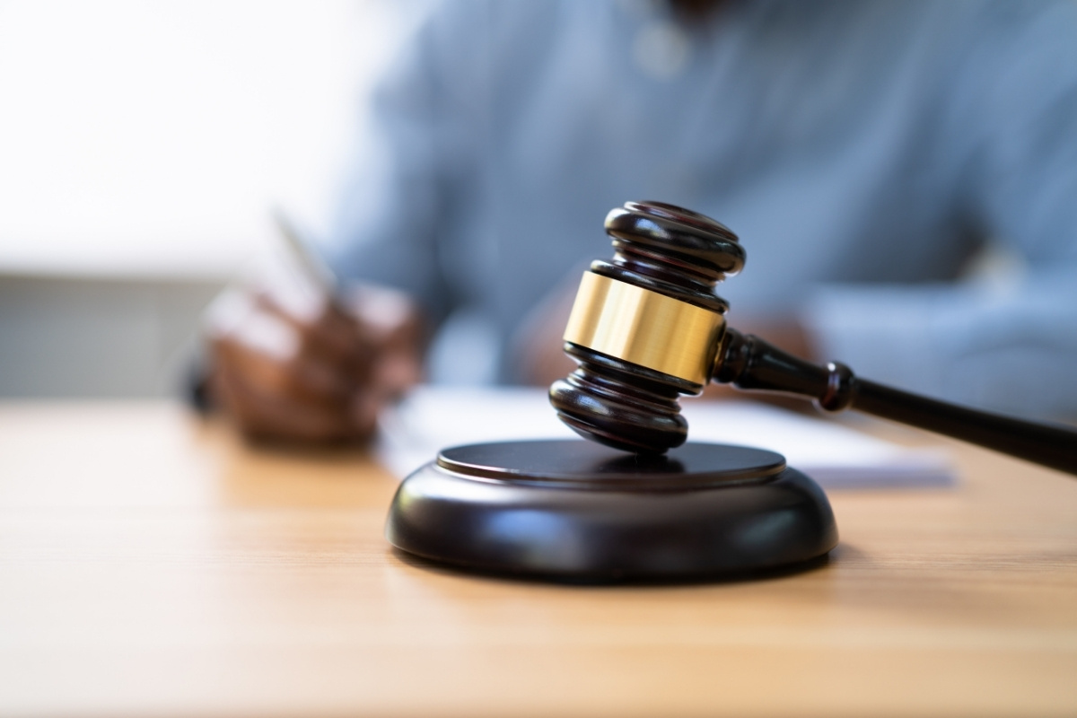 image showing gravel with a lawyer blurred in the background